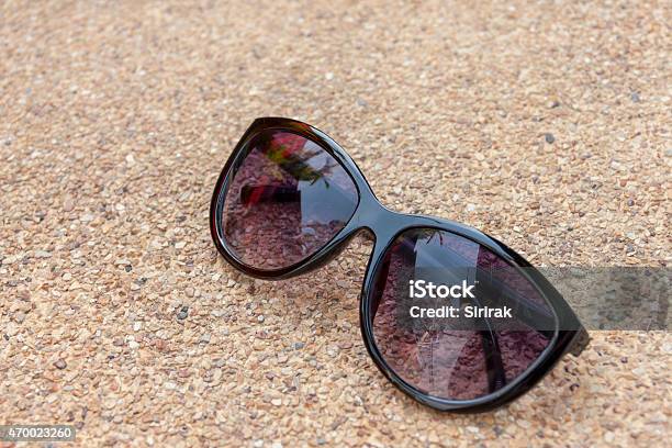 Sunglasses On Stone Floor Stock Photo - Download Image Now - 2015, Brown, Cement Floor