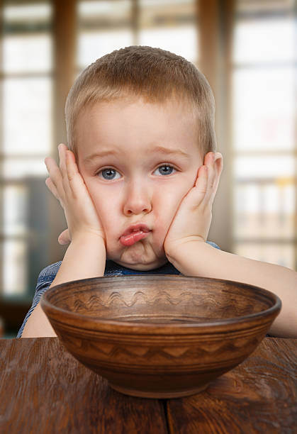 istock Cute blonde naughty boy refuses to eat 470026896