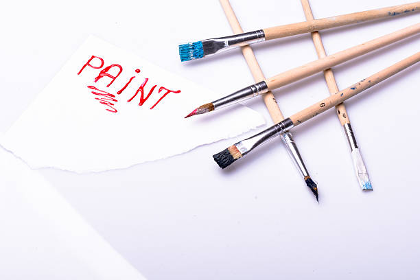 istock Paint word on a white sheet and paint brushes 470027196