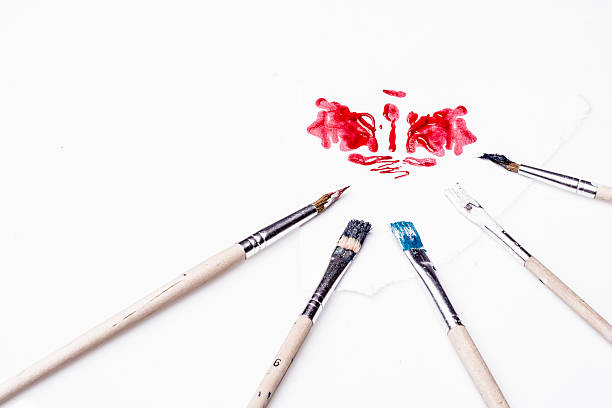 istock Red stain and paint brushes on a white background 470028504