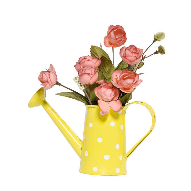 Artificial bouquet in yellow watering can  isolated on white background stock photo