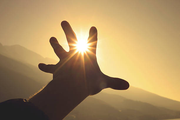 istock Trying to grab the sun with hand 470031598