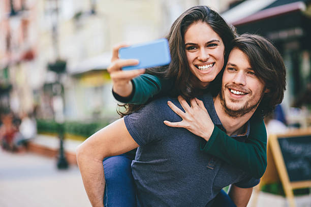istock Happy couple making selfie on the street 470032854