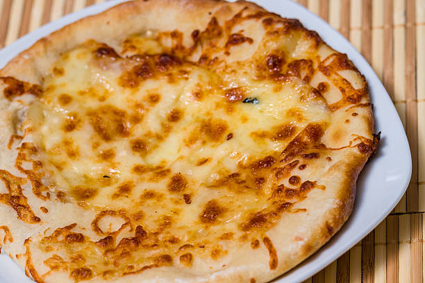 Hot Tasty bread cake with yellow cheese Hot Tasty bread cake with yellow cheese made in fire furnace of bakery large pasta pot stock pictures, royalty-free photos & images