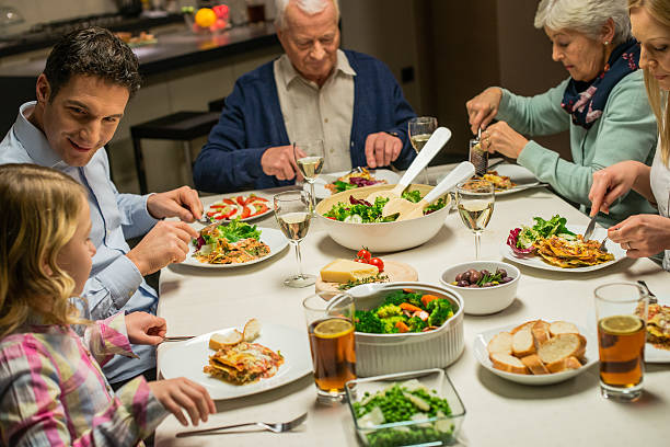 istock Multi generation family enjoying dinner together 470040354