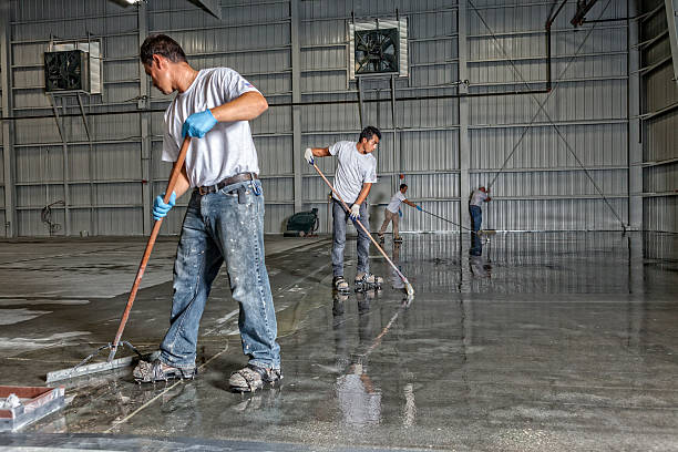 istock Professional Painters Put Down a Coating in Airport Hanger 470040540