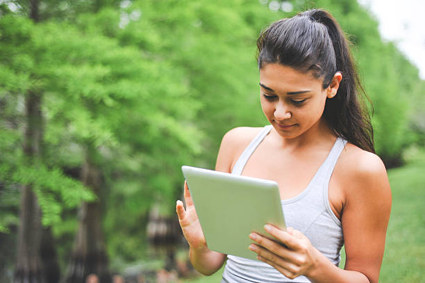 istock Young Woman looking at a digital tablet 470040666
