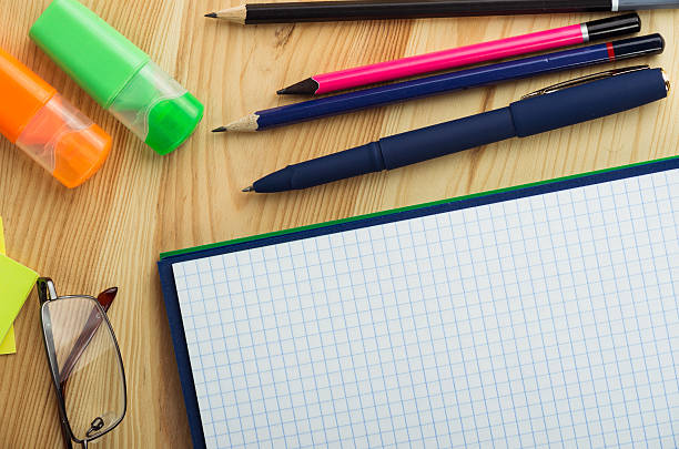 istock Overhead of open notebook with pen and glasses desk 470041712