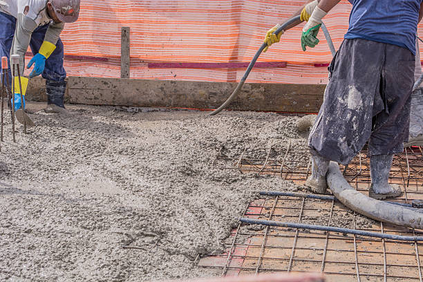 istock Construction worker compacting liquid cement in reinforcement for concreting floors 470042848