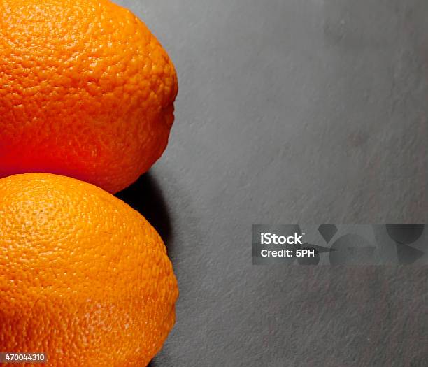 Two Oranges On A Wooden Background Stock Photo - Download Image Now - 2015, Black Background, Food