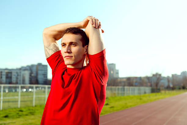 istock Young Athlete  stretching his Arms 470044354