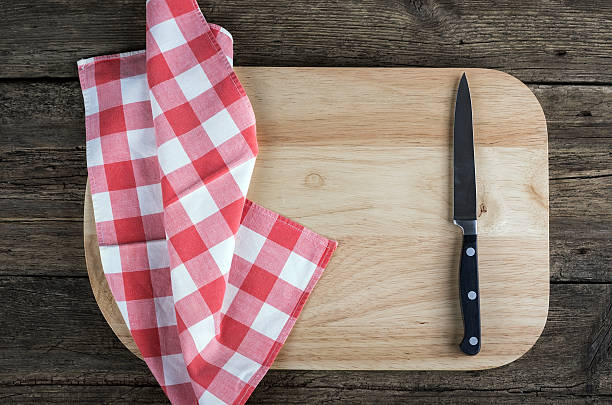 istock knife fork and napkin plaid  a cutting board wooden background 470051286