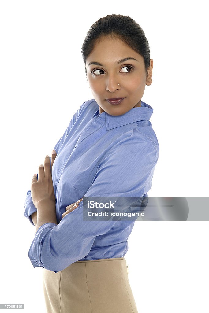 Indian Businesswoman Young Indian businesswoman posing on white background wearing blue shirt and beige skirt. Adult Stock Photo