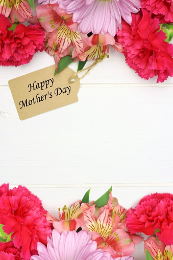 Happy Mother's Day gift tag with double border of pink flowers against white wood background