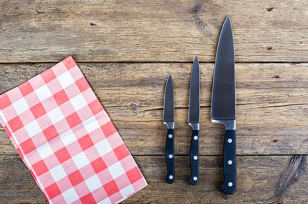 istock Cutting breadboard and knife over red grunge gingham tablecloth background 470055400