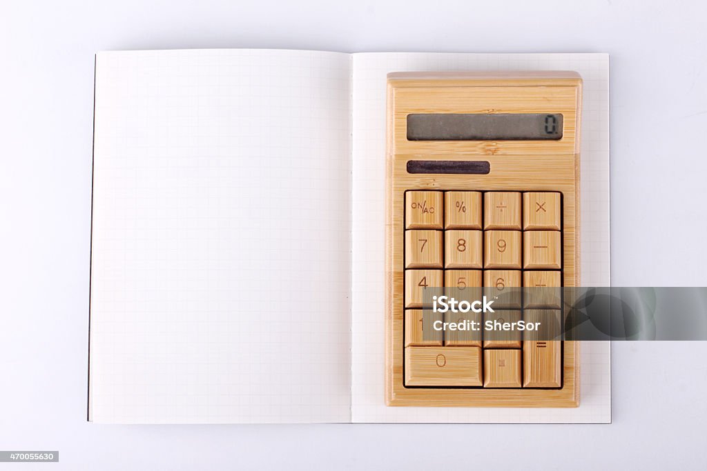 Open notebook on white background blank notebook with wooden calculator on white background, business concept 2015 Stock Photo