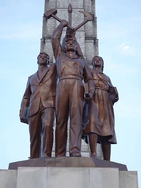 istock Three idealised figures in front of The Juche Tower 470056990