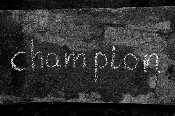istock The word CHAMPION written with chalk on black stone. 470059744