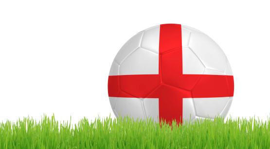 Soccer ball on green grass with colors of England flag isolated on white background