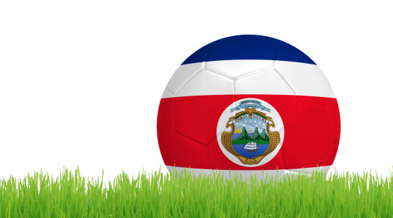 Soccer ball on green grass with colors of Costa Rica flag isolated on white background