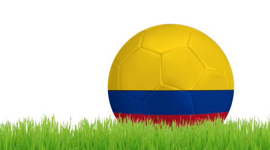 Soccer ball on green grass with colors of Colombian flag isolated on white background