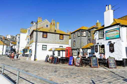 St. Ives, United Kingdom - April 28, 2011: Town and harbour of St. Ives in Cornwall, England, UK.  In former times the town was dependant on fishing, however, with the decline in the fishing industry the town is now primarily a popular tourist resort.