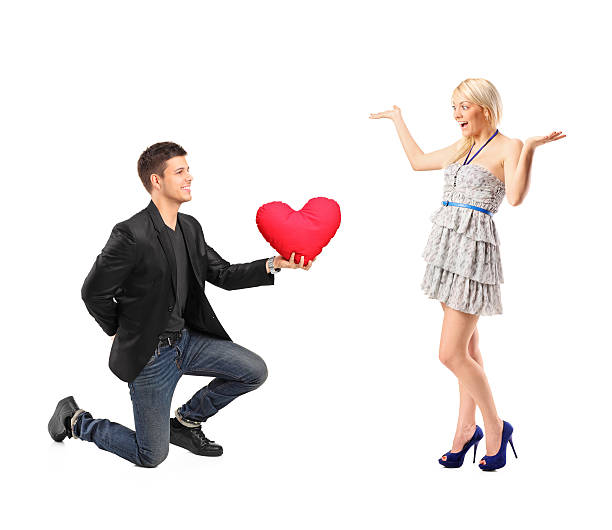 istock Romantic man giving a heard pillow to a girl 470065316