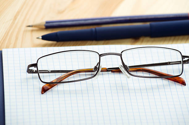 istock Overhead of open notebook with pen and glasses desk 470065558
