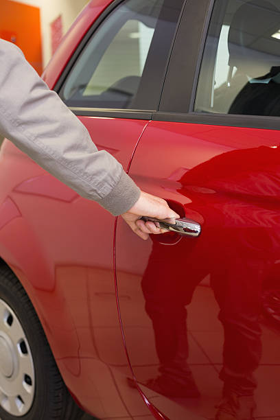 istock Man holding a car door handles 470065920