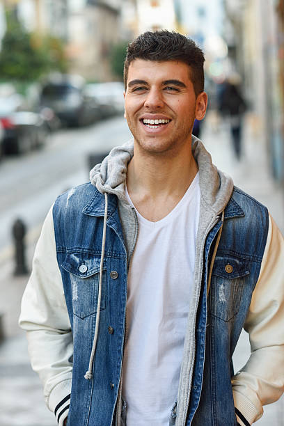 istock Handsome young man with blue eyes posing near a wall 470066284