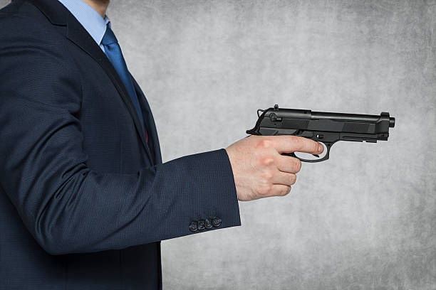 istock businessman holding a gun 470069336