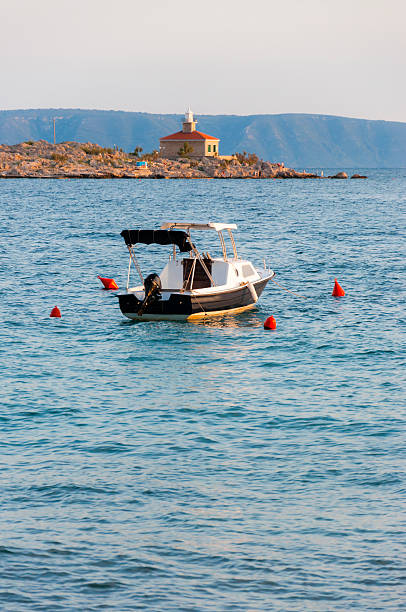 istock Passenger boat and lighthouse on the Adriatic sea at sunset 470069360