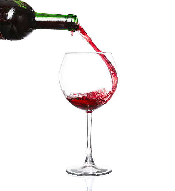 istock red wine pouring into wine glass isolated 470070138