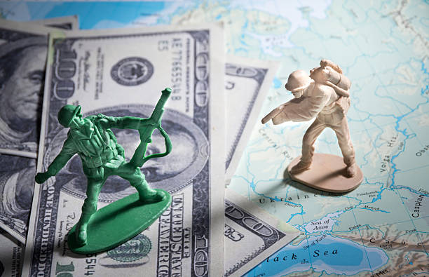 istock Soldier toys on money and map. 470070550