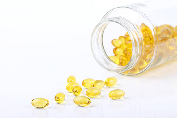 istock vitamin capsules  poured out of bottle 470071248