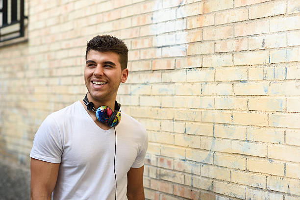 istock Young man in urban background with headphones 470072314