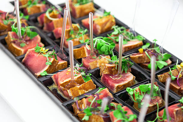 Grilled tuna chunks served with fresh green herbs stock photo