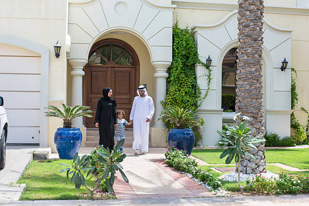 istock Arab family walking in front of their house 470077620