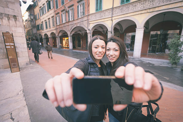 istock Female Twins Taking a Selfie in the City. 470077782
