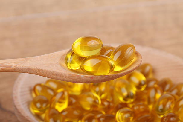 istock spoon of vitamin capsules 470078872