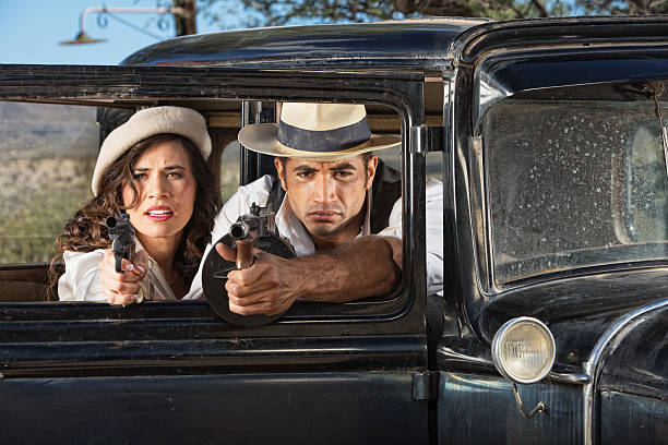 istock 1920s Male and Female Gangsters 470080363