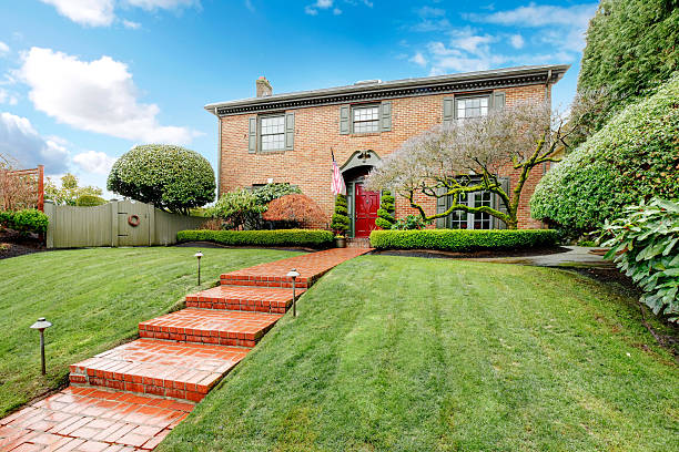 istock Pretty two story brick house with stoned walkway 470083365
