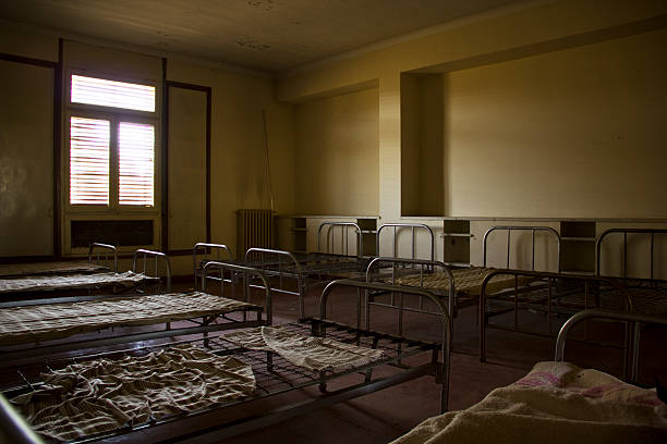 istock Beds in an abandoned room 470085606