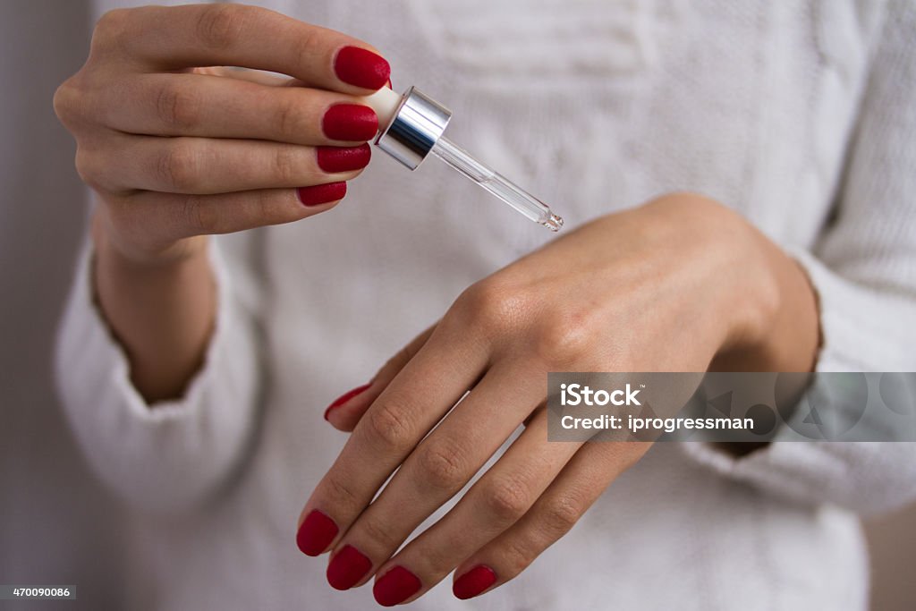 Hands to apply the serum female hands used serum on a white background 2015 Stock Photo