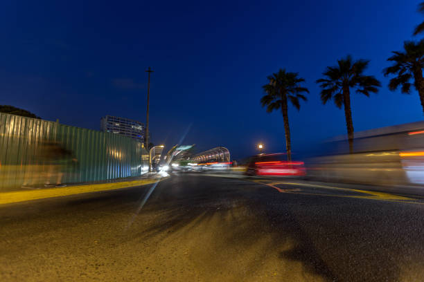 Lima, Peru - January 13, 2015: Night time traffic on Lima roads. Cars, taxis and joggers make their way across a bridge at Miraflores