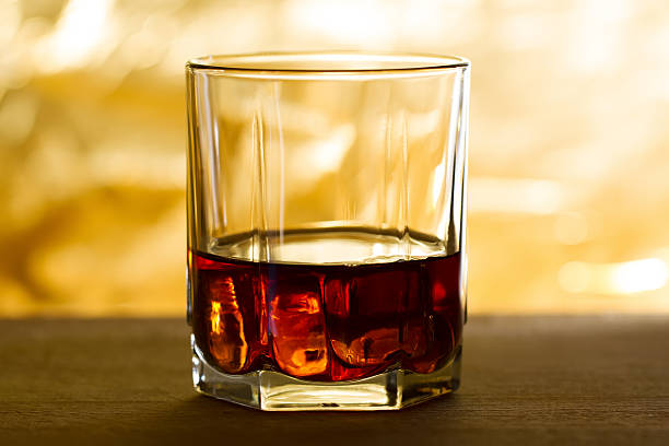 istock whiskey with ice on a wooden table 470095486
