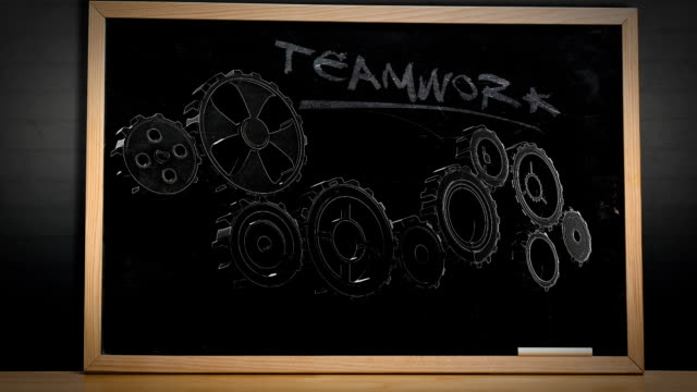 Cogs and wheels turning on blackboard