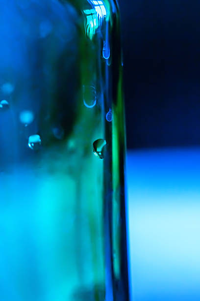 istock Water drops on blue-green glass bottle 470100036