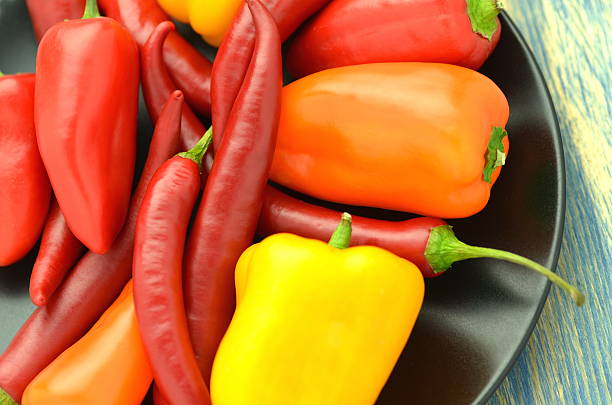 istock variety of different peppers on black plate 470101924