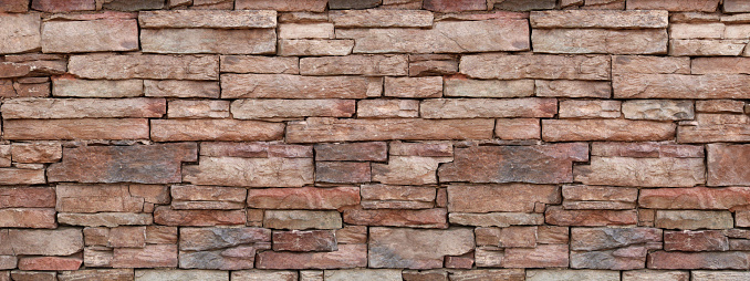 A long section of an old brick wall.